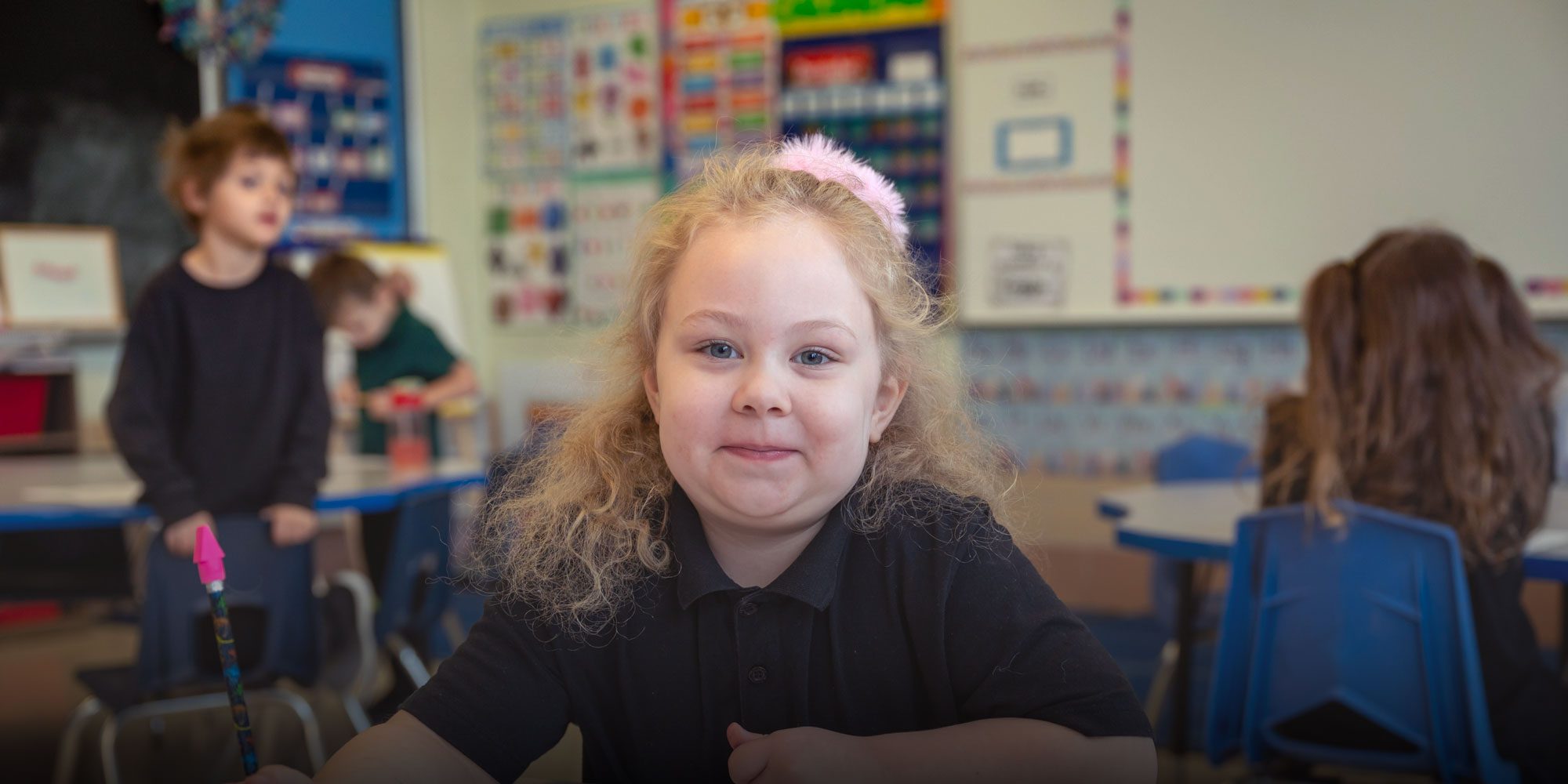 smiling student sitting at desk